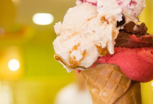 An ice cream cone with many scoops.