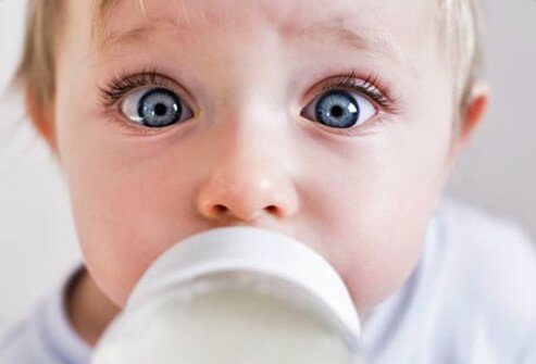 A baby with a milk bottle.